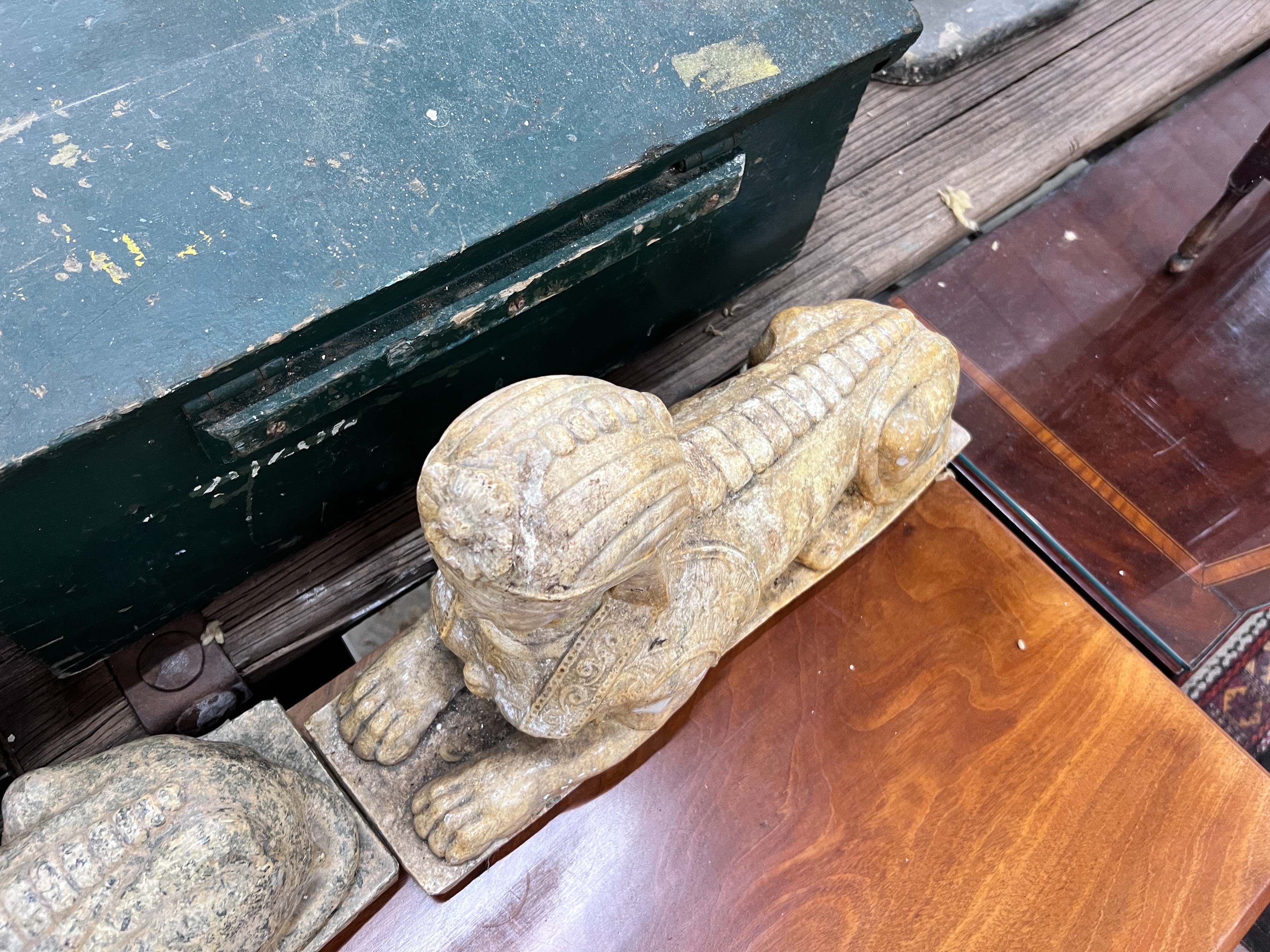 A pair of composition faux marble sphinx, length 48cm, height 30cm *Please note the sale commences at 9am.